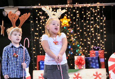SINGING "Rudolph, the Red-nosed Reindeer" are K4 student Tucker Thompson and Kindergarten student Shaelyn Barnes during the Eastport Elementary School's Christmas concert on December 15. (Ed
