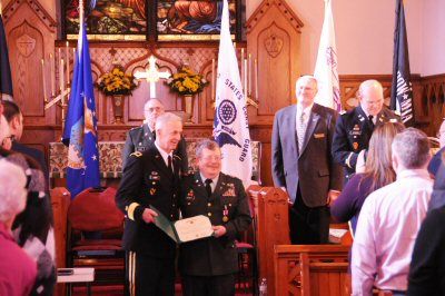 HONORING DAVID SIVRET on the occasion of his promotion to major and retirement from the Maine National Guard is Maine National Guard Major General John W. "Bill" Libby. The ceremony was held