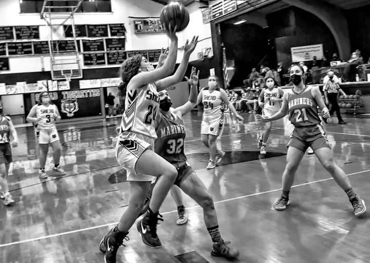 DRIVING TO THE BASKET to score two points during a high school basketball game against Deer-Isle Stonington on January 24 is Shead Tigerette Ashlee Morang. See this issue for coverage of the
