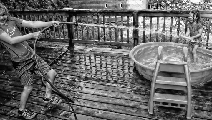 KEEPING COOL on a hot June day are Keen Cooke, 7, and his three-year-old sister Loa, as they play in their pool by their home in Eastport. The temperature reached 80 degrees in the island ci