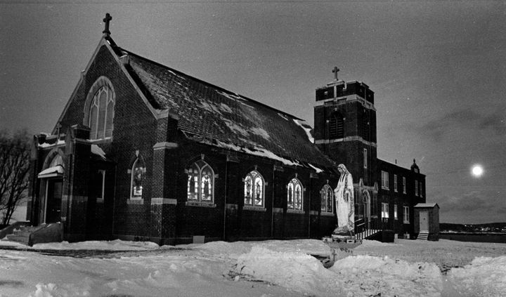 ST. ANN'S CHURCH at Sipayik, which is scheduled to be demolished in the coming weeks, is seen lit up on a snowy evening with a full moon shining across Passamaquoddy Bay during the Christmas