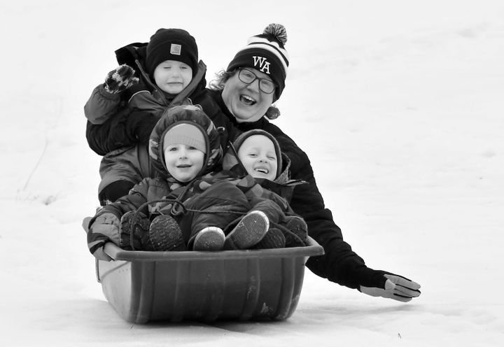 HAVING FUN sliding during the Stronghearts Winter Sports and Fun Day on February 13 are Wanda Kirshman with Harbor Seeley, Lucca Stevens and Carter Fitzsimmons. (Don Dunbar photo)