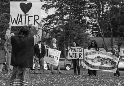 DEMONSTRATING against the proposed Tomah Water project were over two dozen people from around Maine outside the Indian Township tribal office on Sunday, October 20. See this issue for covera