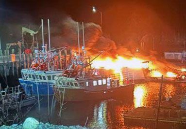 AN EARLY MORNING FIRE at the Head Harbour wharf on Campobello on December 13 destroyed two fishing boats and a scow. Local firefighters and fishermen were able to save the nearby boats as we