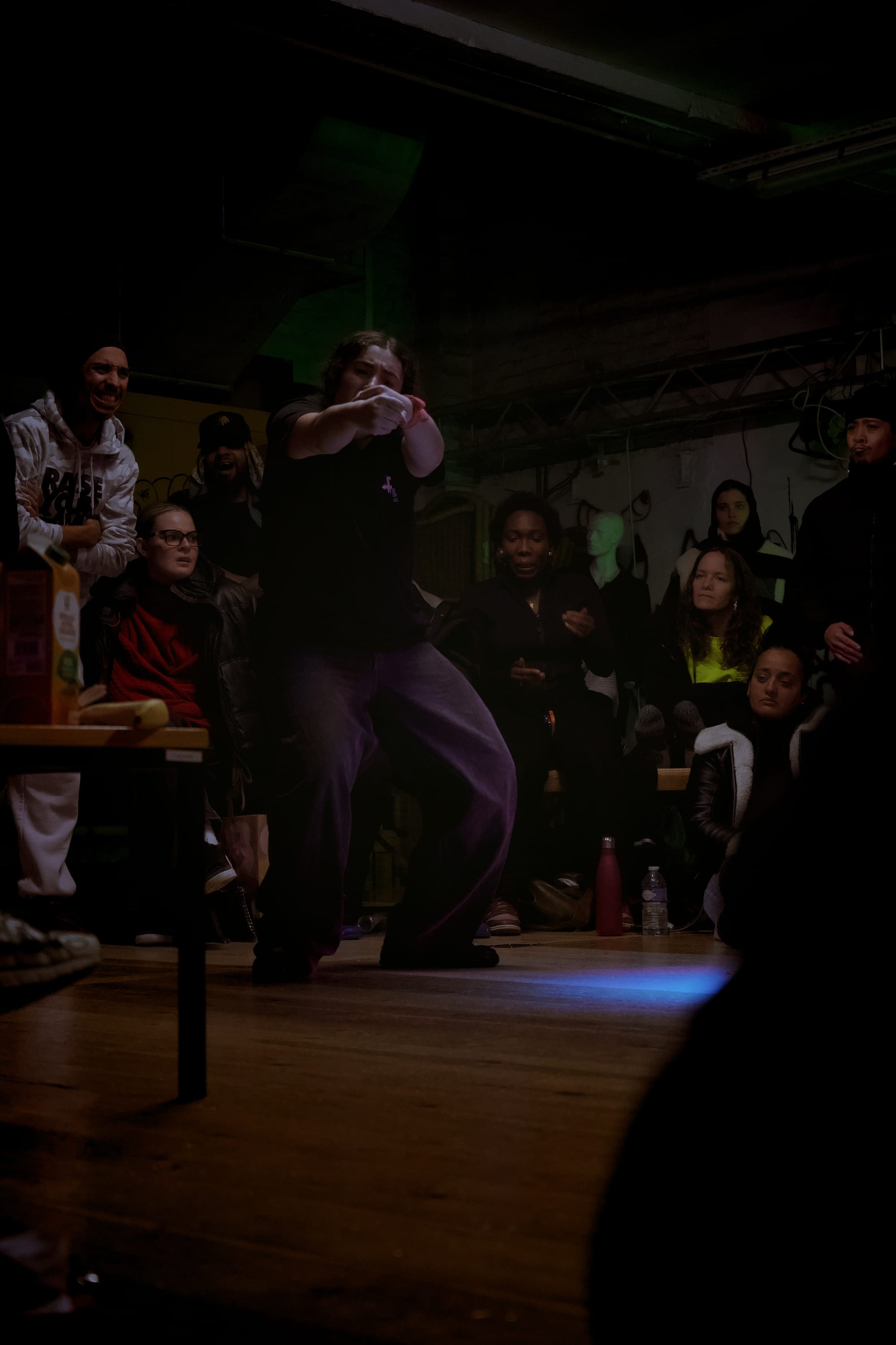 A Krumper dancing with the audience around them.