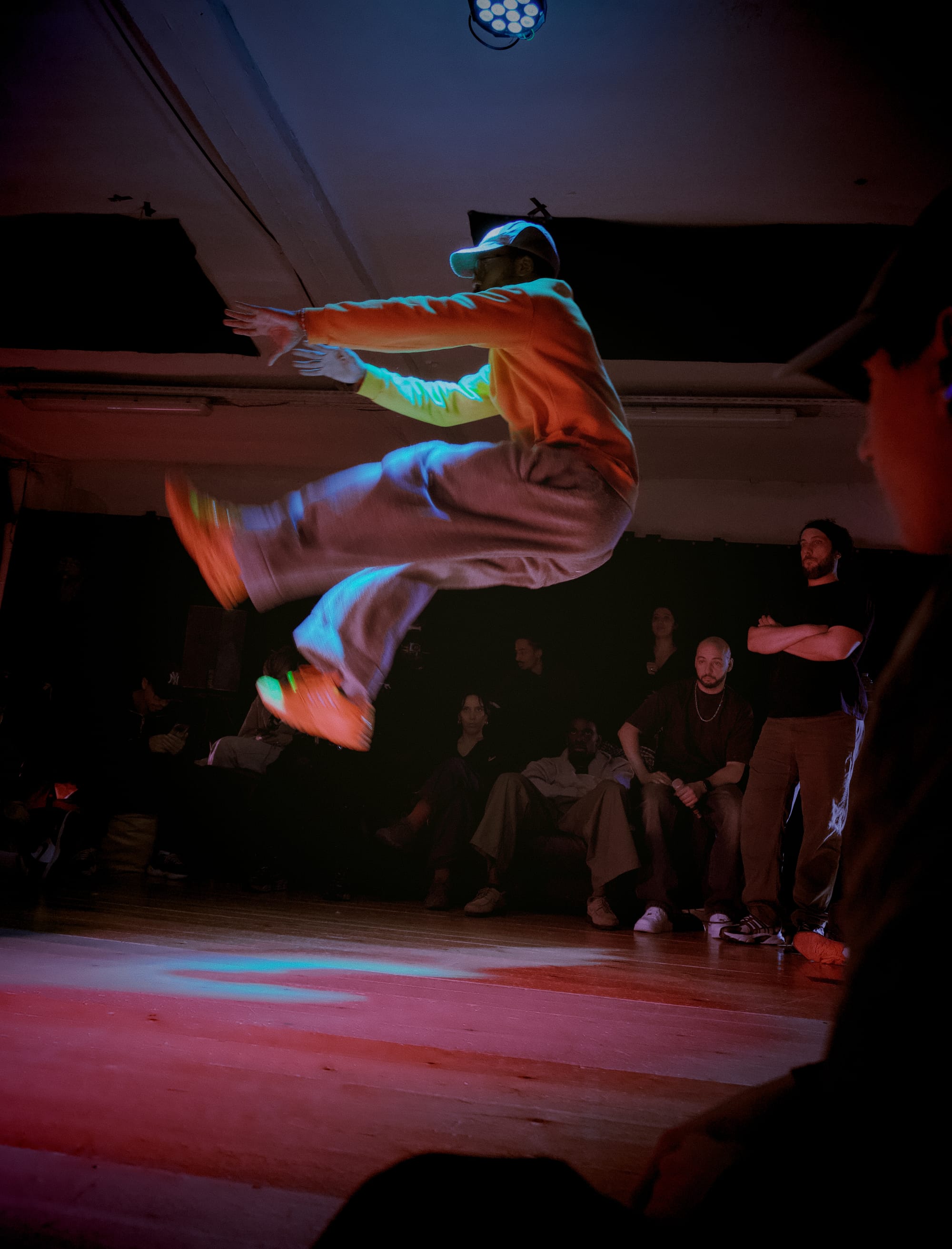 Do Eazy jumps in the air while dancing, in the middle of the dance floor.