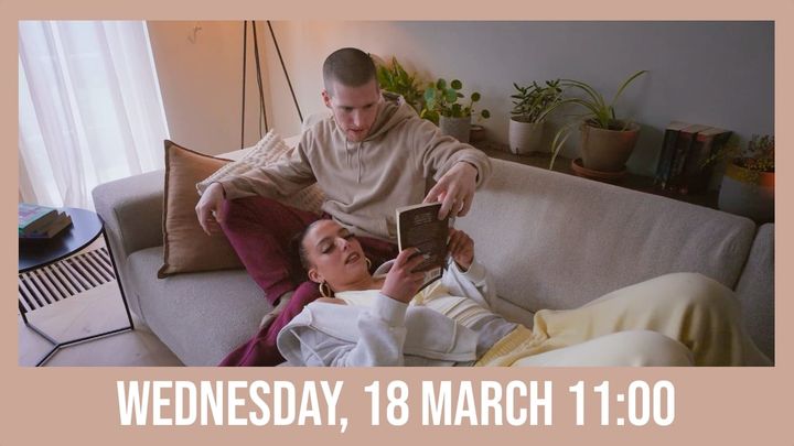 Slim B and Pippa are sitting on a couch reading the same book together.