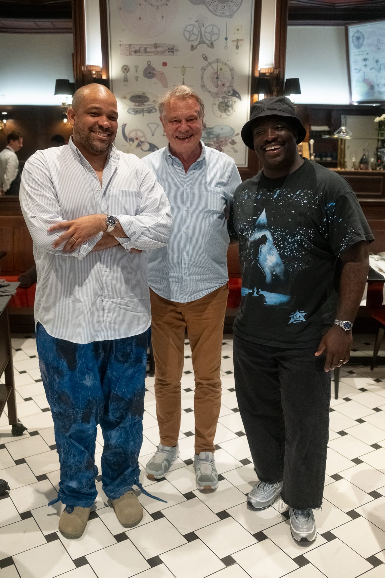 F.P. Journe’s François-Paul Journe standing between Perri and Rashawn, smiling inside the restaurant’s tiled dining area.