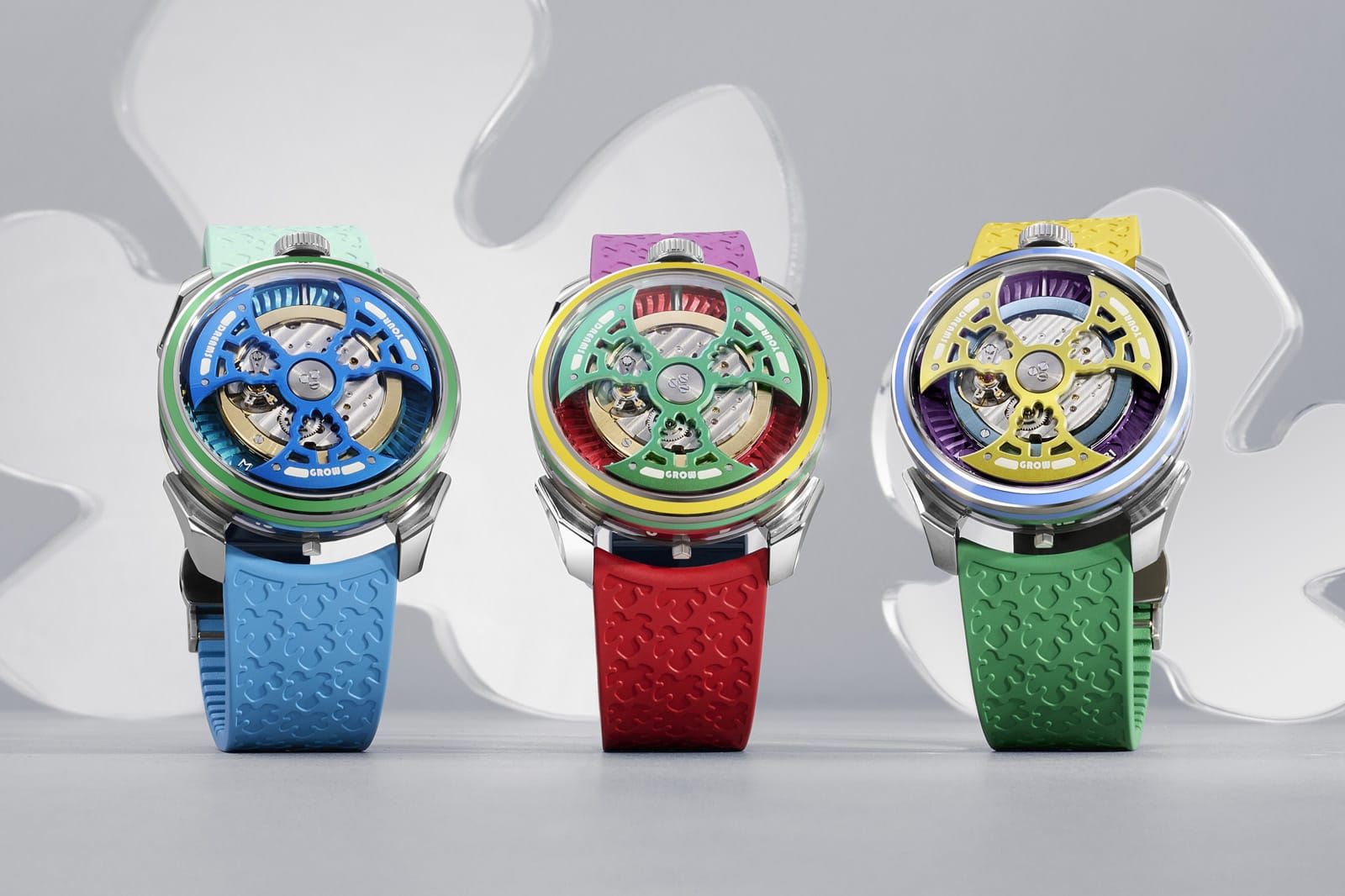 Three colorful mechanical watches from the Grow Your Dreams collection with open dials and bold rubber straps in blue, red, and green, blending playful color with precision engineering.