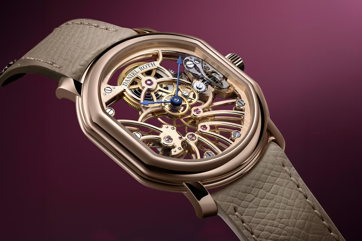 Daniel Roth Extra Plat Rose Gold Skeleton watch with double-ellipse case and openworked movement on a beige leather strap, shown against a deep burgundy background.