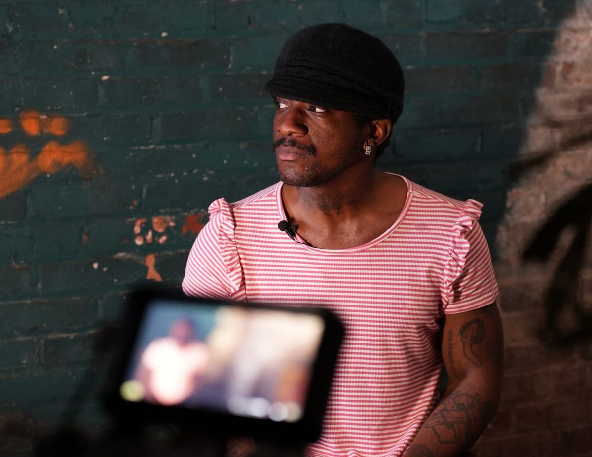 Menyelek Rose standing in front of a camera posing for portrait