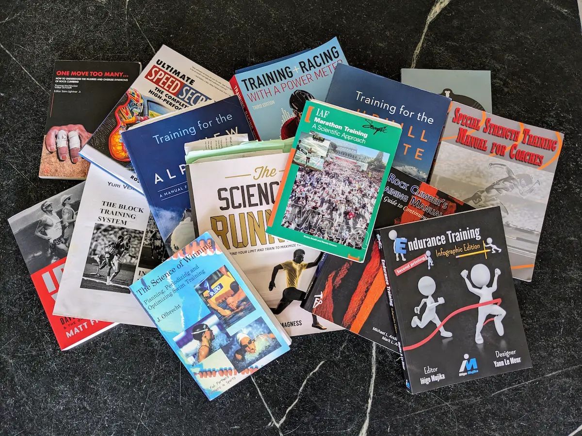 A photo of a pile of training books on a counter top