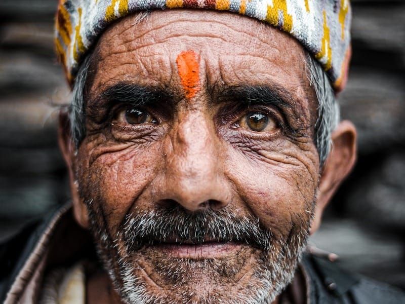an old man with a colorful turban on his head