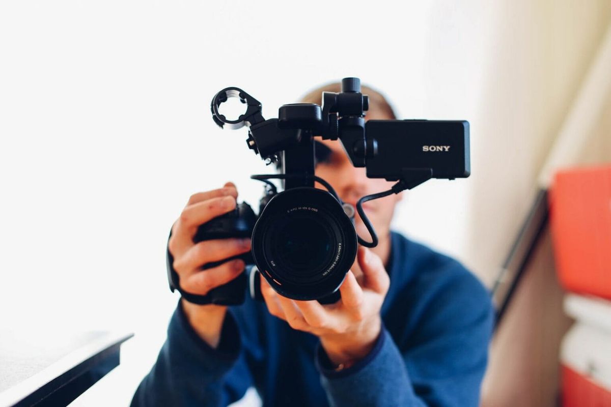 A man with a DSLR camera in hand