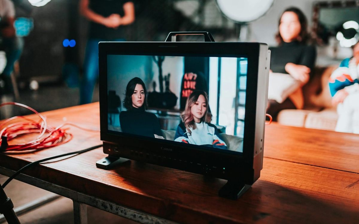 An image of two individuals being recorded in front of a camera