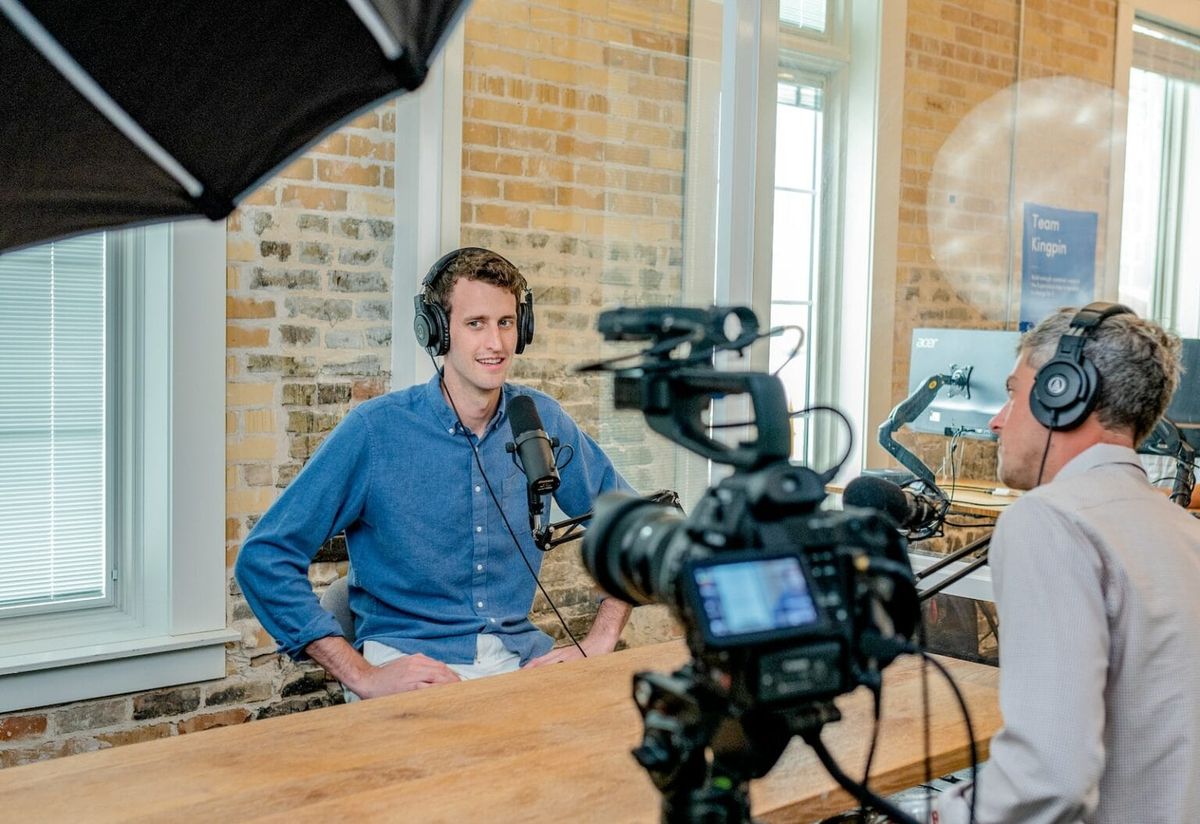 A man being recorded while wearing a headset