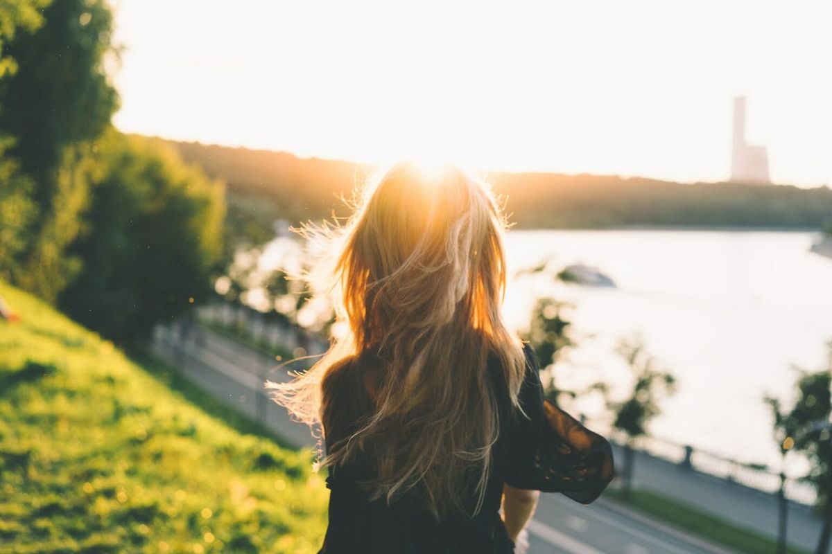 A shot of an individual in front of a sunset