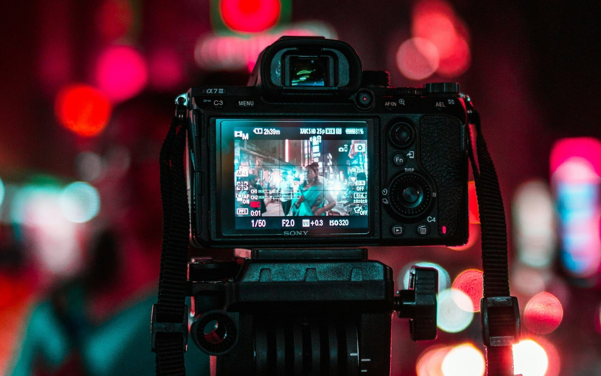 a camera pointing at a woman out on the street
