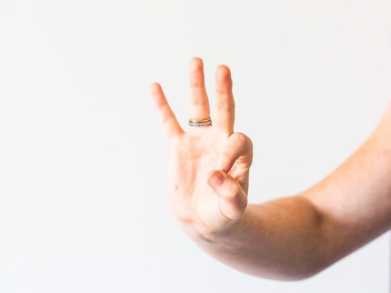 persons hand doing thumbs up