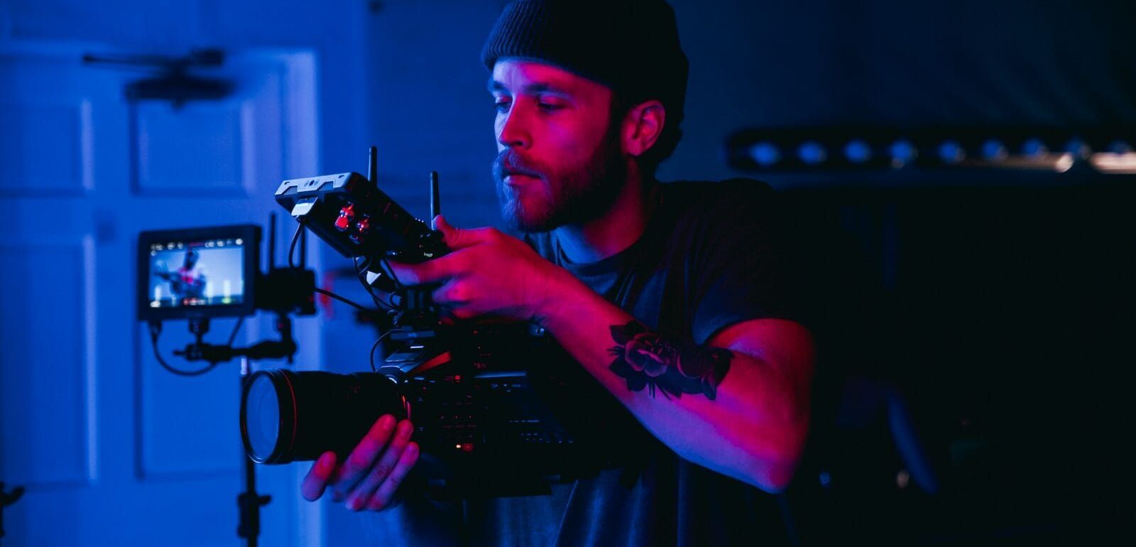 A man shooting in a dark-lit room