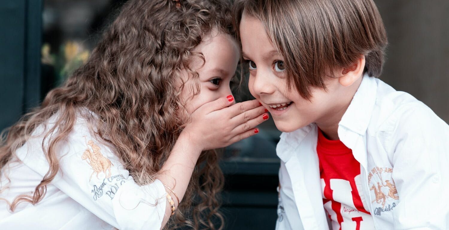 A child whispering to another child
