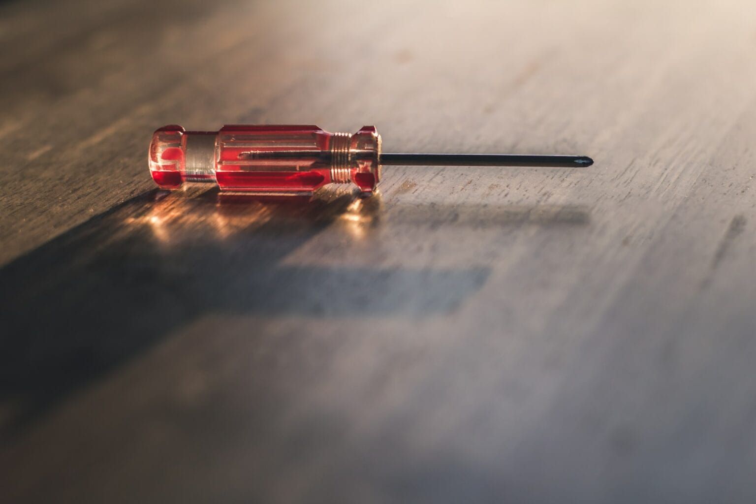 A red screwdriver laid on a table
