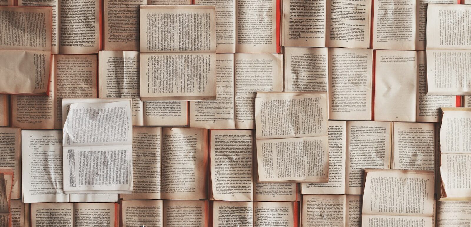 A bunch of open books overlaid upon eachother