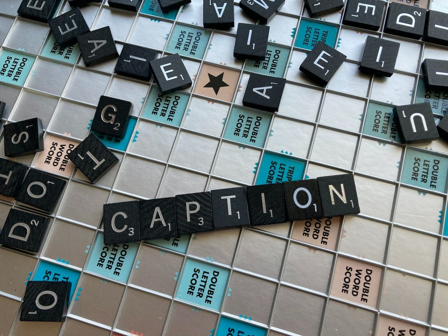 A set of Scrabble titles spelling out the word "Caption"