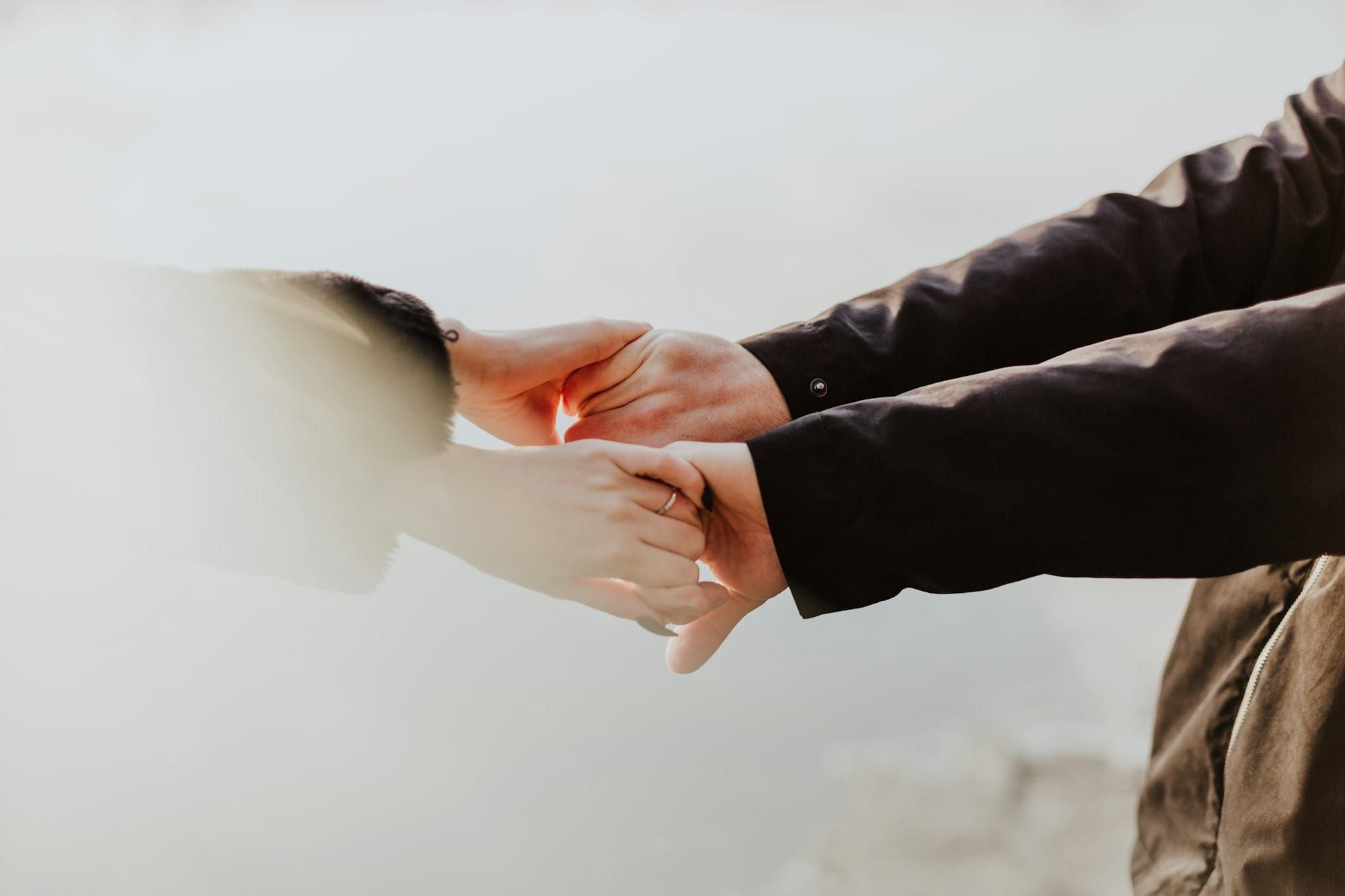 A photo of two individuals holding hands
