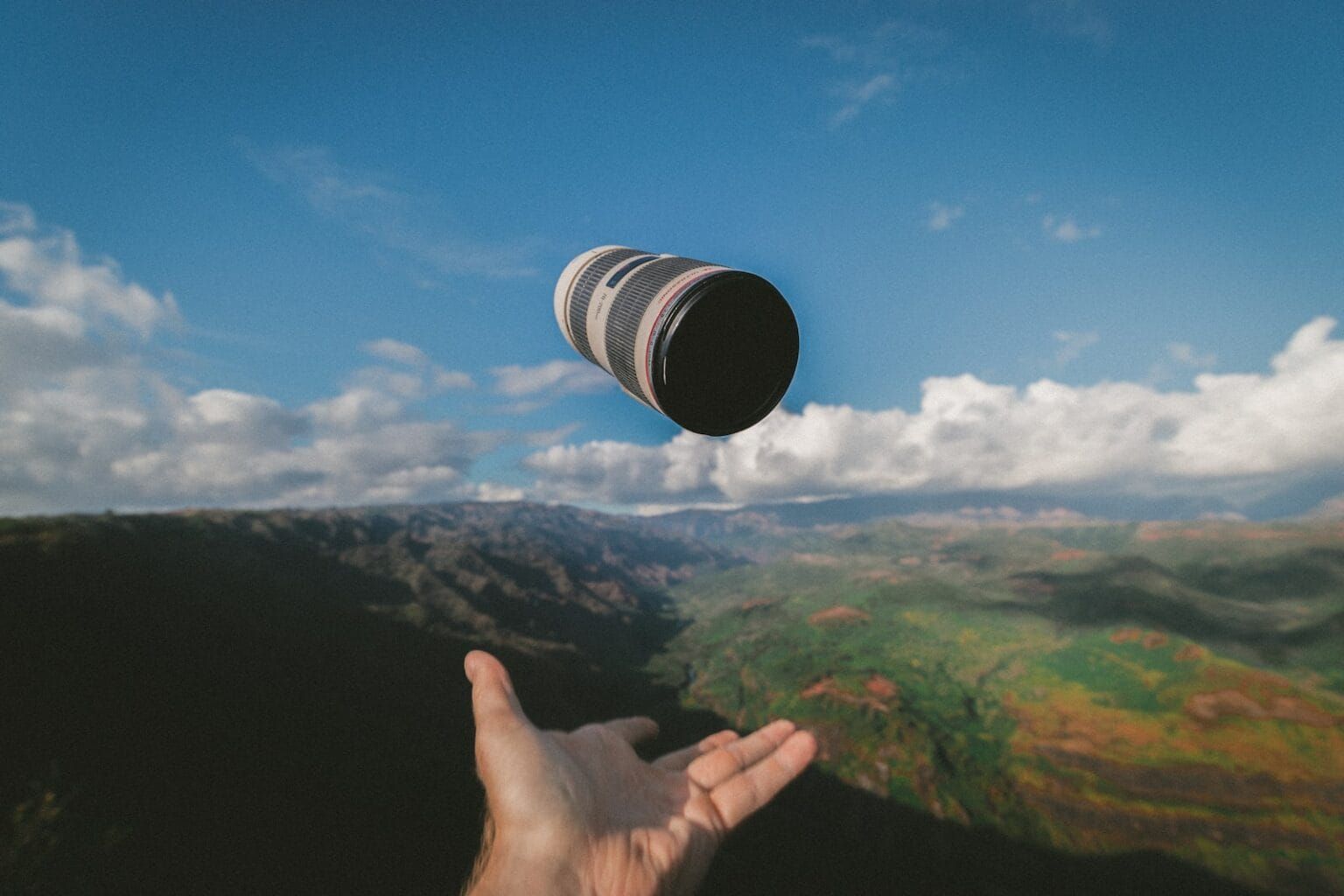 An image of a camera lens tossed in the air