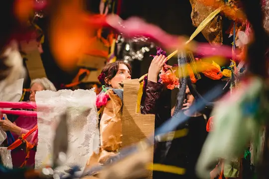 A person painting a giant, colourful costume for a Day of the Dead celebration