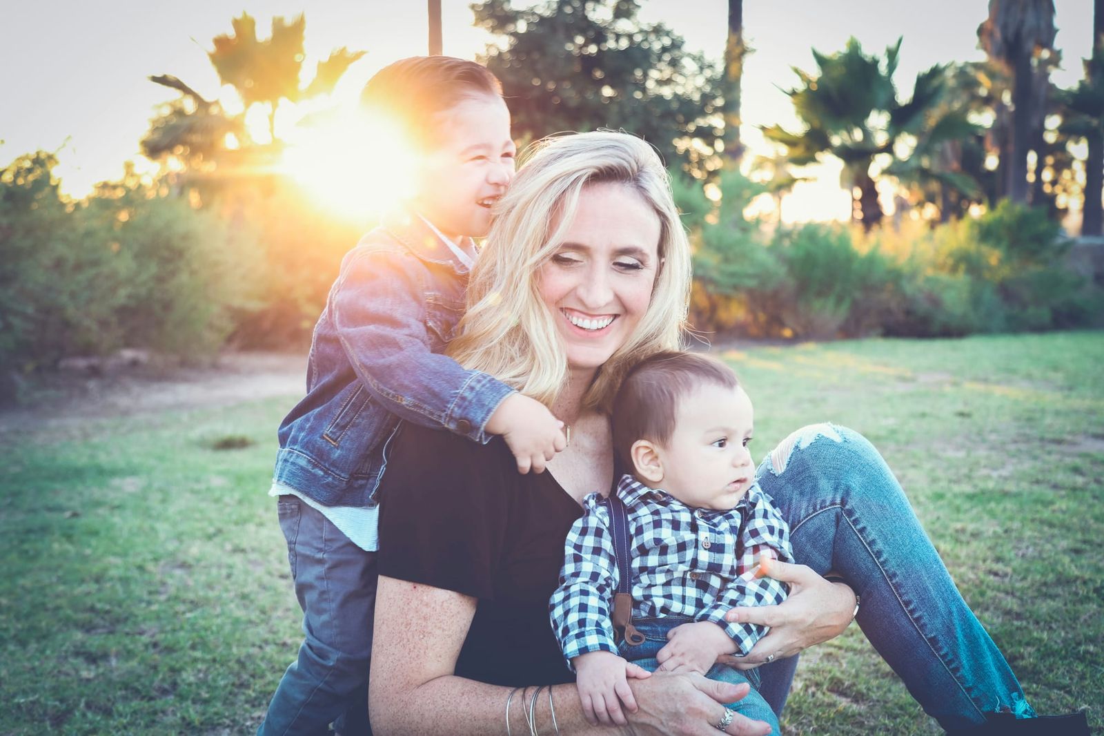 Photograph of a mother and her children in a natural setting with late evening sun shining on them