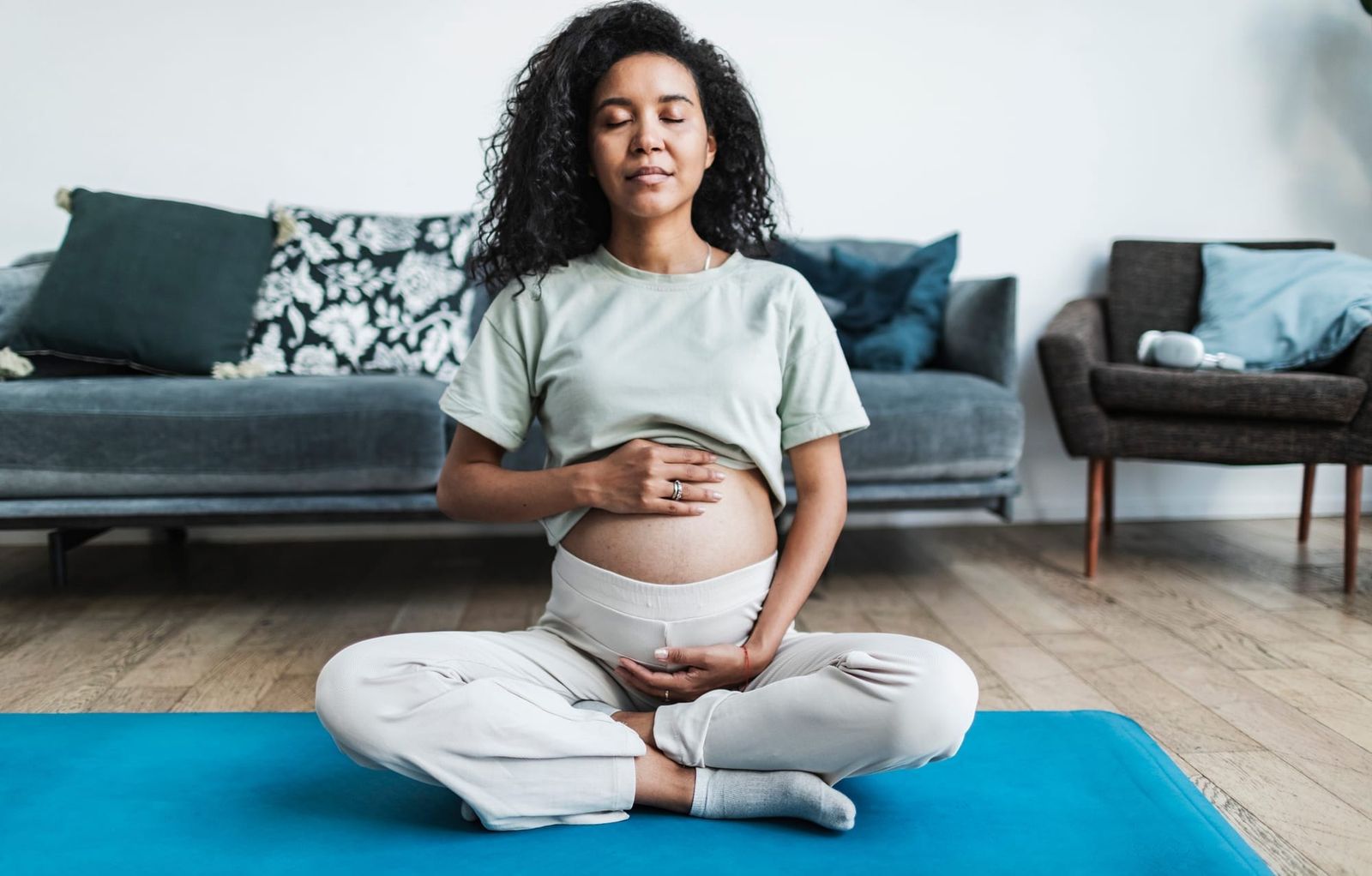 pregnant woman on yoga mat breathing