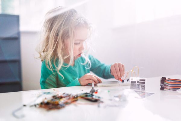 Image of a young child engrossed in scientific play