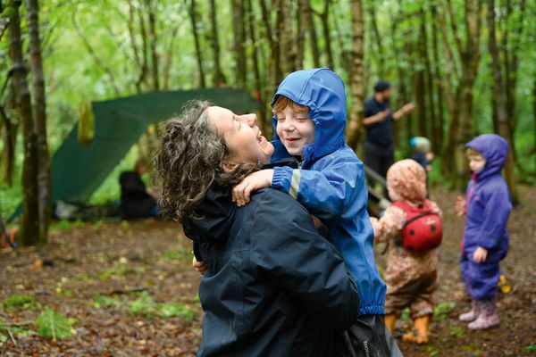 woman holding child woodland