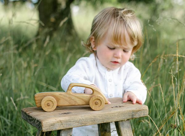 child playing with wooden toy