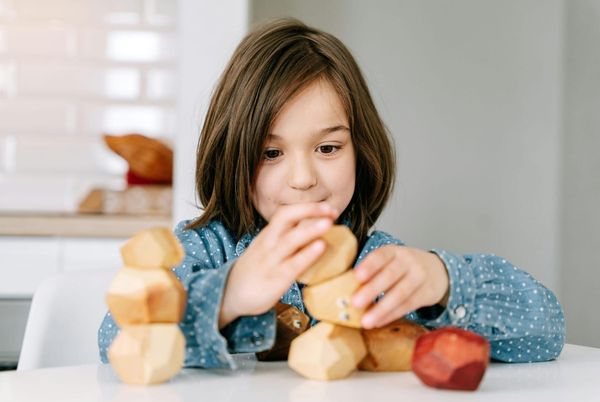 girl playing with blocks school