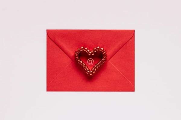 The back of a red envelope with a red heart in the middle.