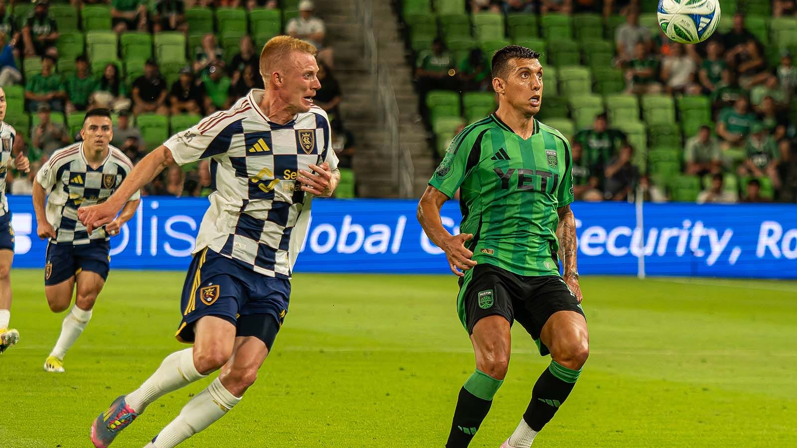 RSL's Justen Glad and Austin FC's Myrto Uzuni watching a ball