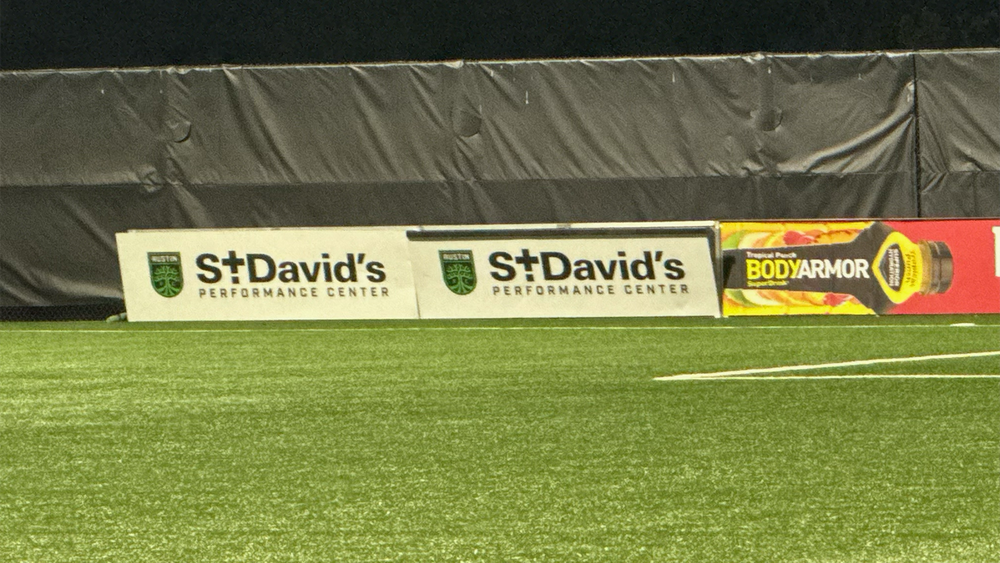 Broken ad board at Austin FC II match