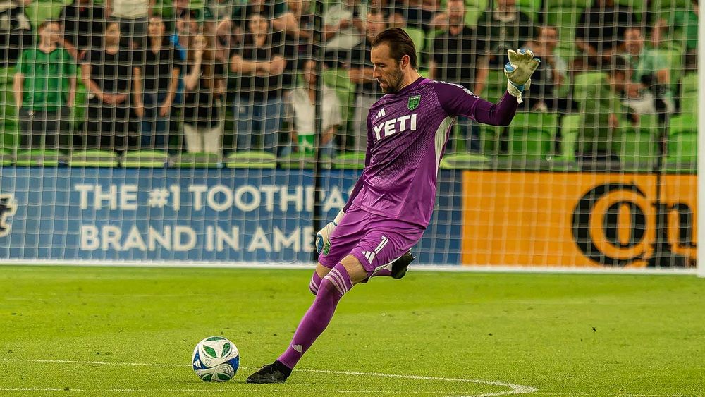 Austin FC goalkeeper Brad Stuver in purple jersey executing a goal kick