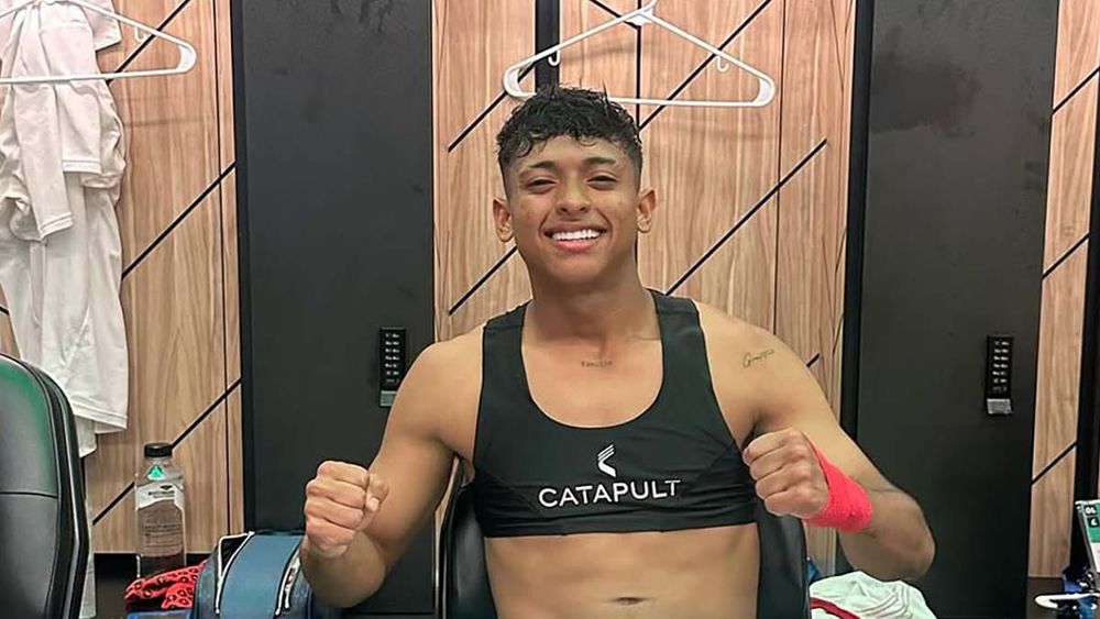 Kervin Andrade sitting in Venezuela locker room with fists raised in celebration after Copa America win 