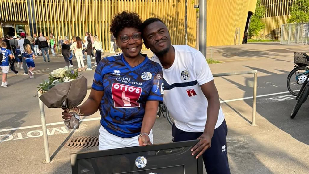 Nicky Beloko standing with his mom outside of FC Luzern's home stadium