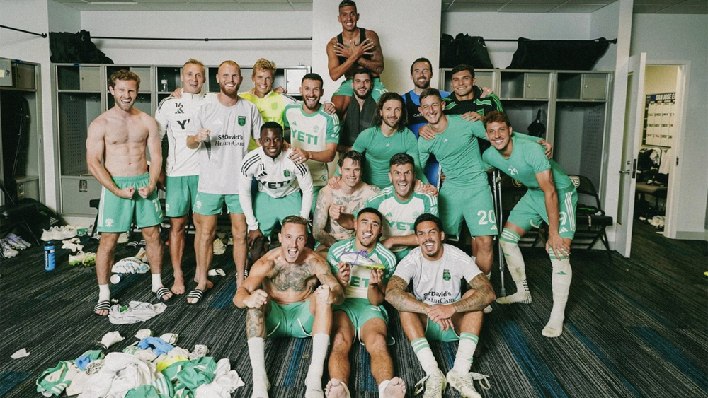 Austin FC players posing in locker room after Open Cup win over San Jose