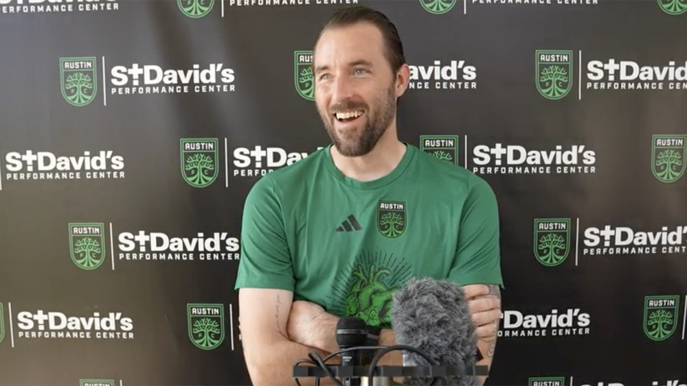 Austin FC goalkeeper Brad Stuver smiling at a media event 