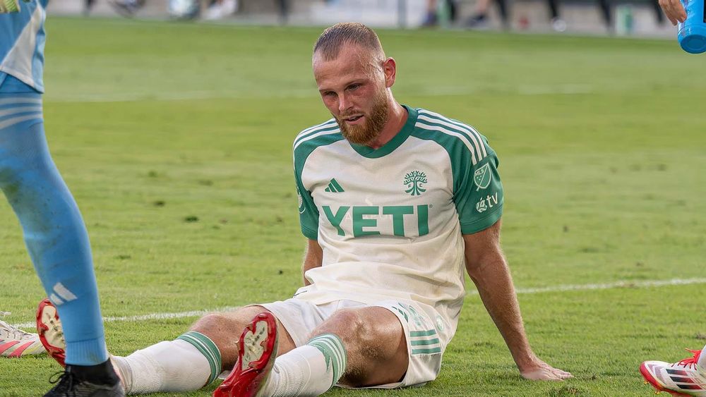 Mikkel Desler injured and sitting down on field during Austin FC match