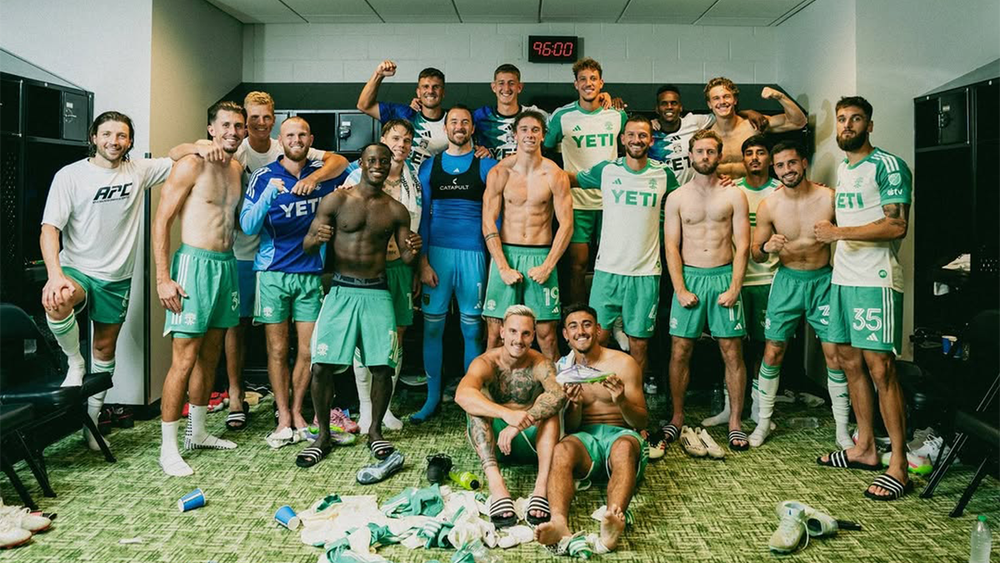 Austin FC players celebrating win over SKC in traditional away match locker room photo