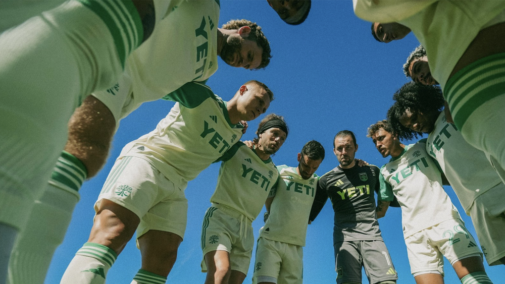 Austin FC players huddling before a match against SKC at the 2026 Coachella Valley Invitational