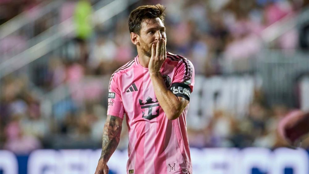 Lionel Messi with hand over mouth in a Leagues Cup match