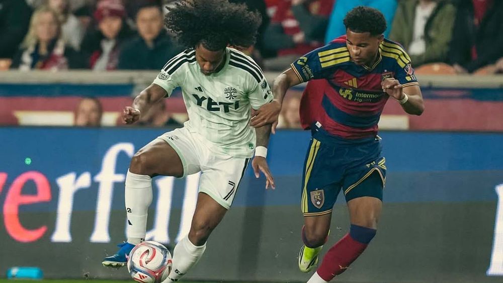 Austin FC's Jayden Nelson dribbling a ball, guarded by RSL's Xavier Gozo
